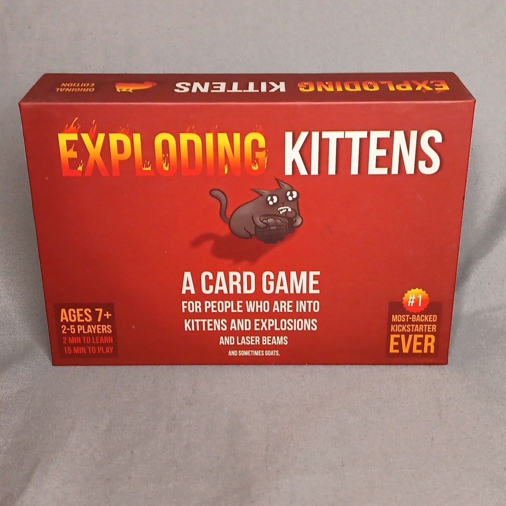 Card Game Exploding Kittens. Opened box, but cards are still wrapped in plastic.